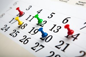 large wall calendar with needles